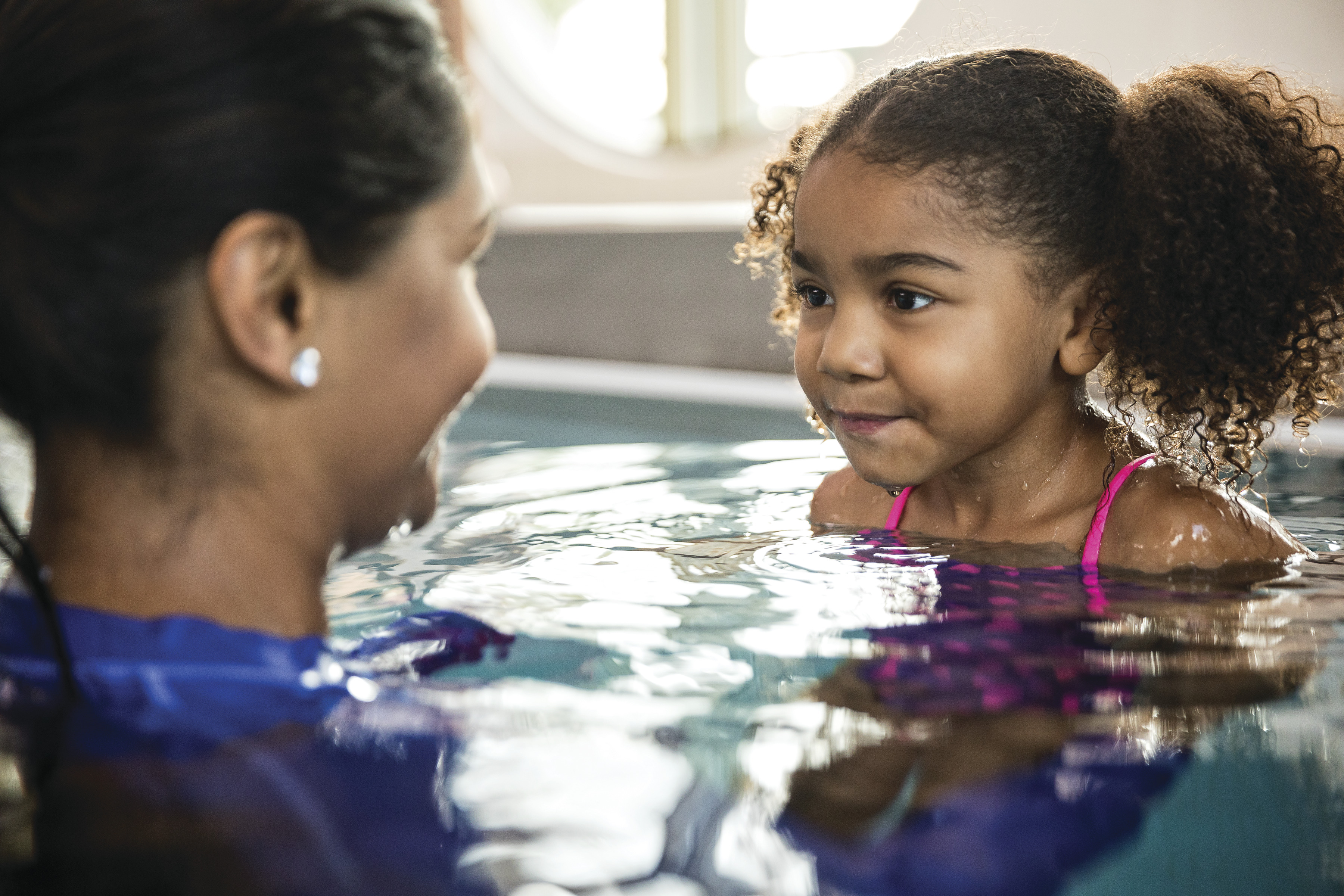 Adult and child in a pool