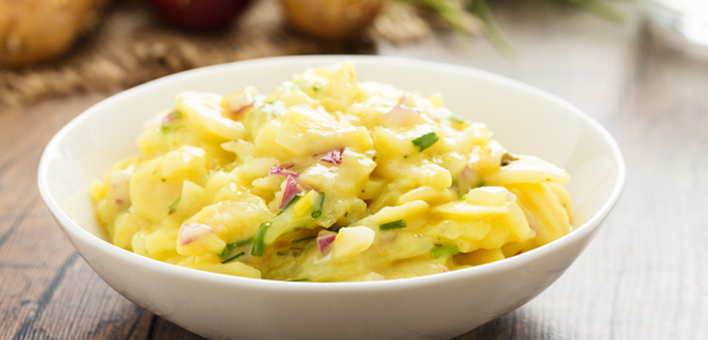 Potato salad in a white bowl