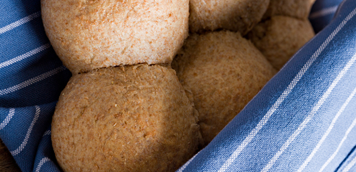 Wheat bread rolls wrapped in a blue cloth