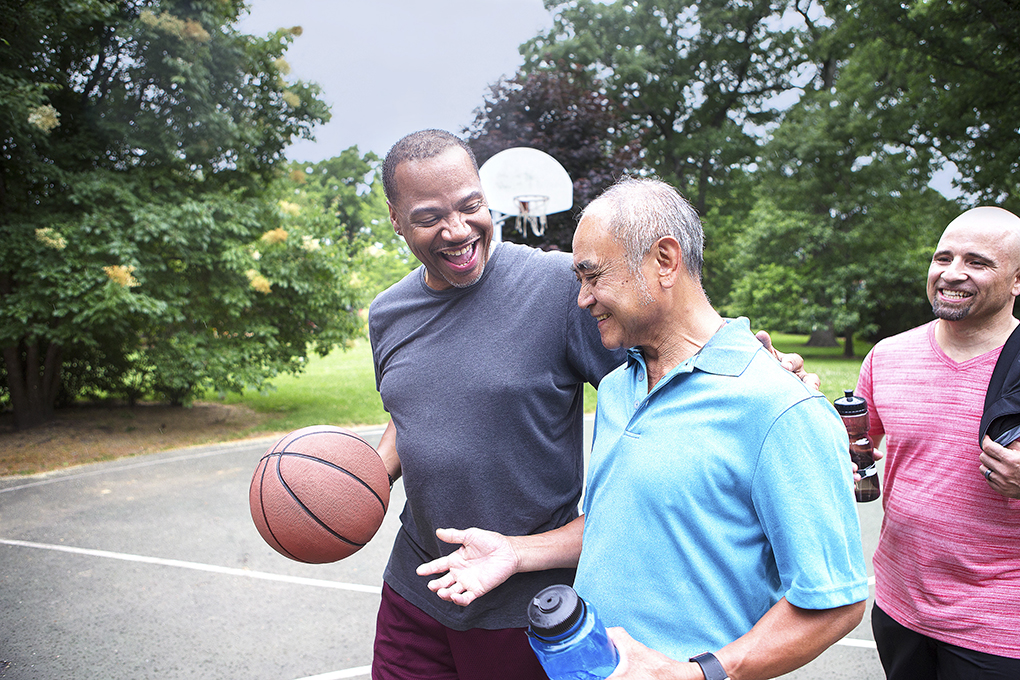 Men on outdoor basketball court walking off - YMCA