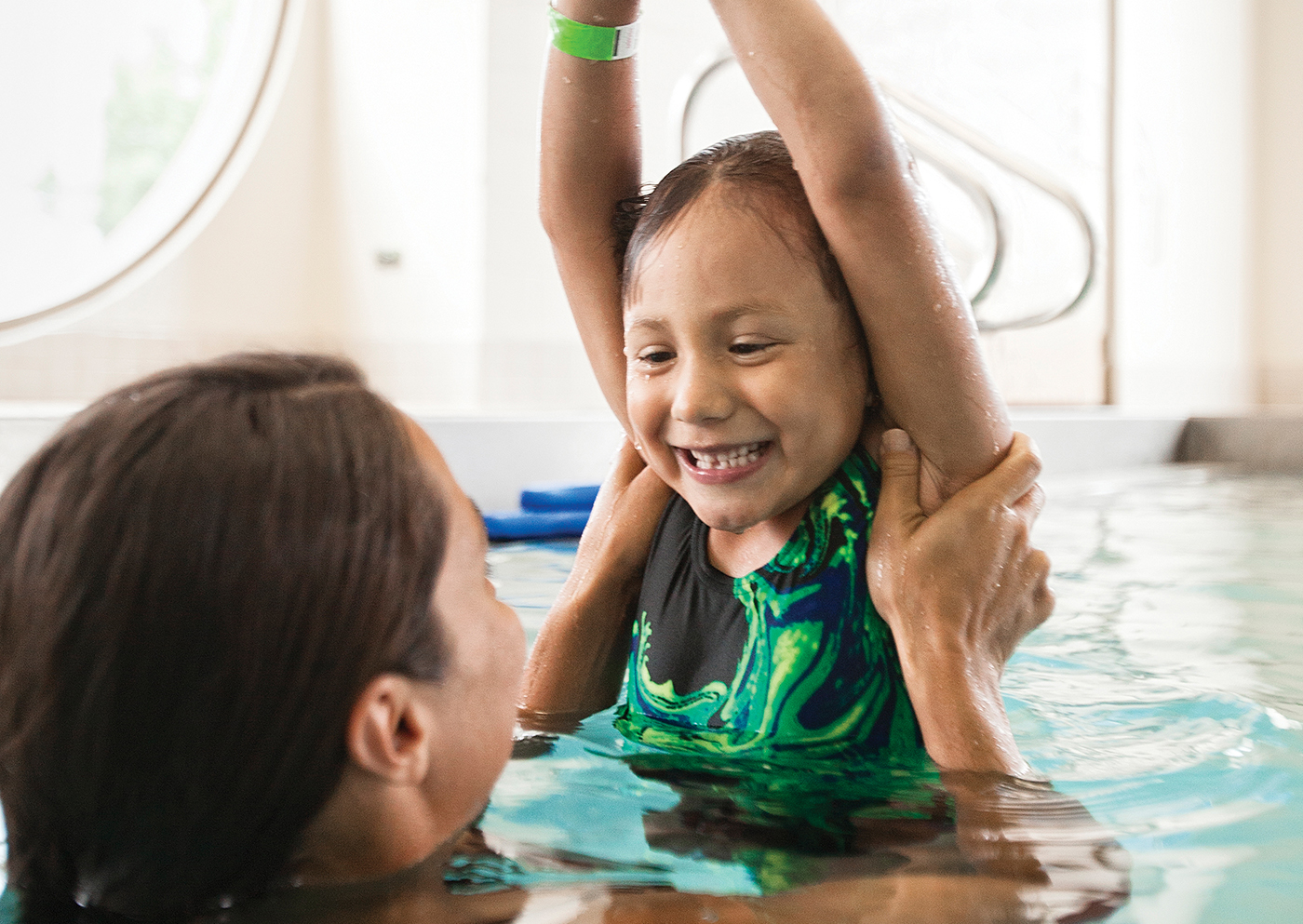 Child and parent swimming at YMCA