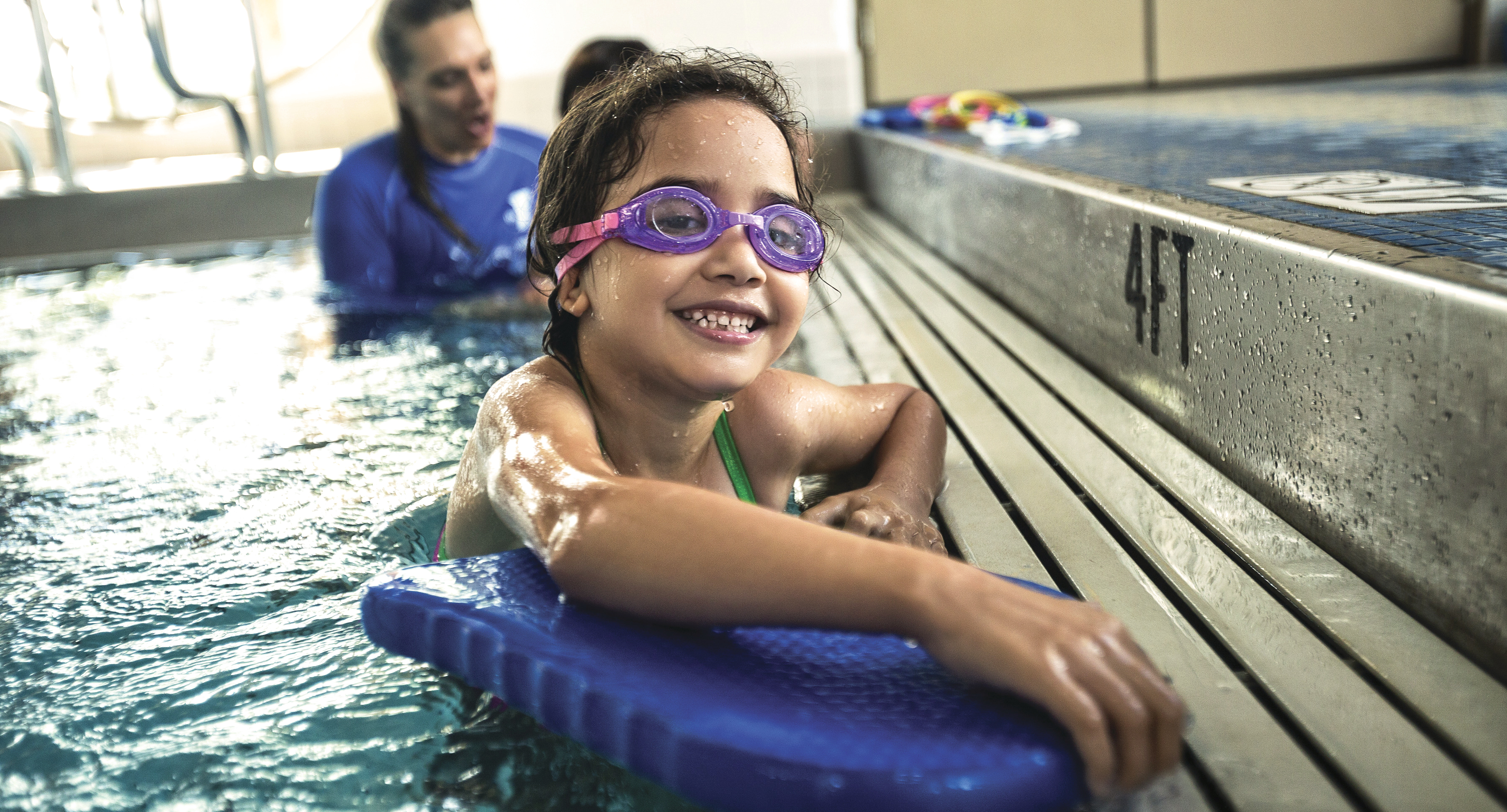 Child and instructor swimming at YMCA