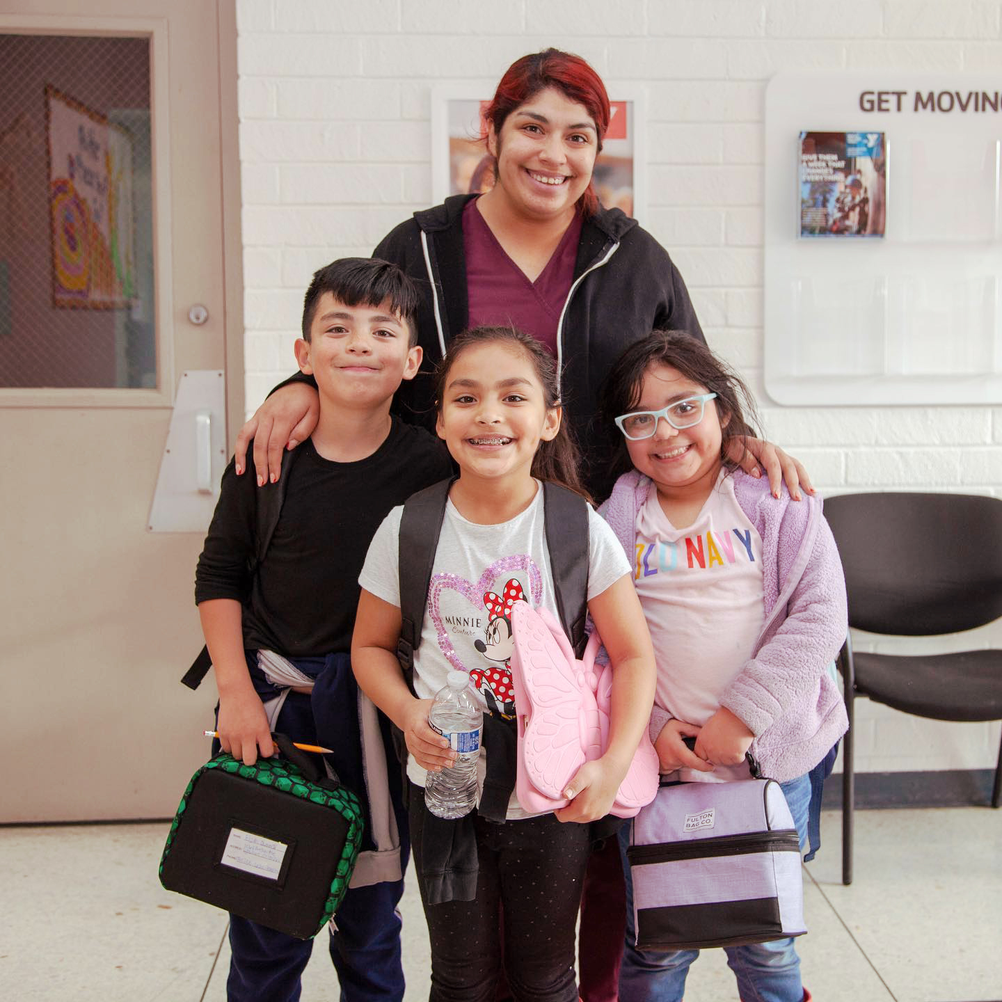 Children standing with their mom at the Y