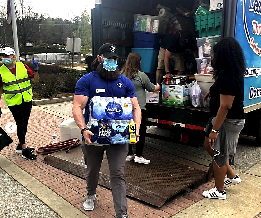 People unloading a truck volunteering