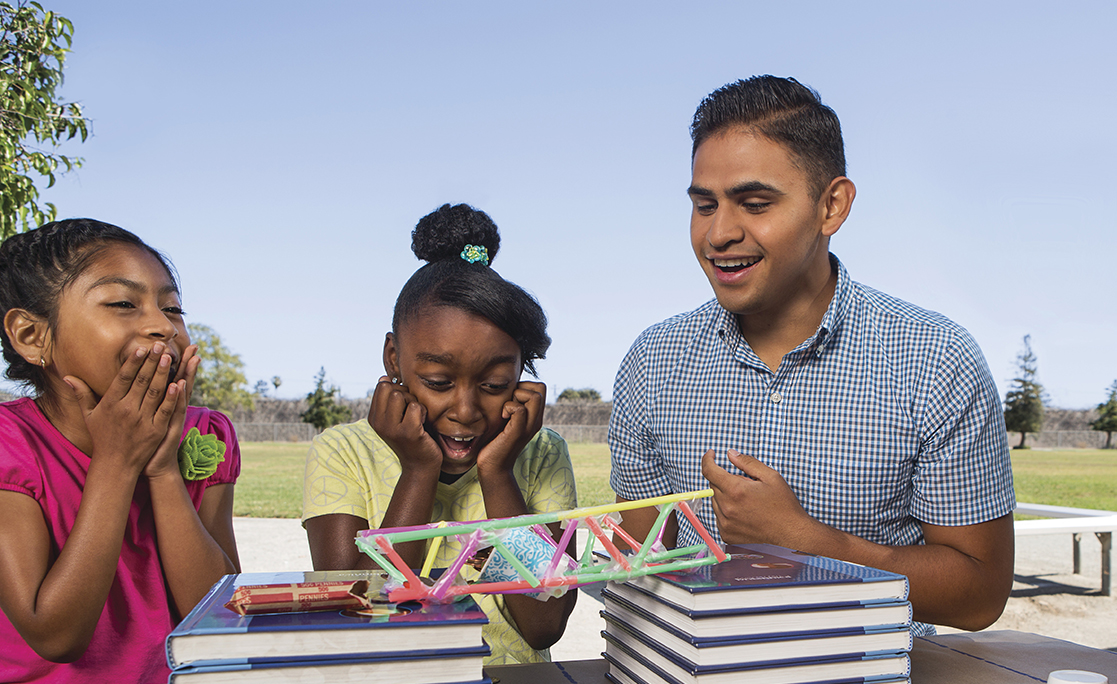 Children and man eating lunch together
