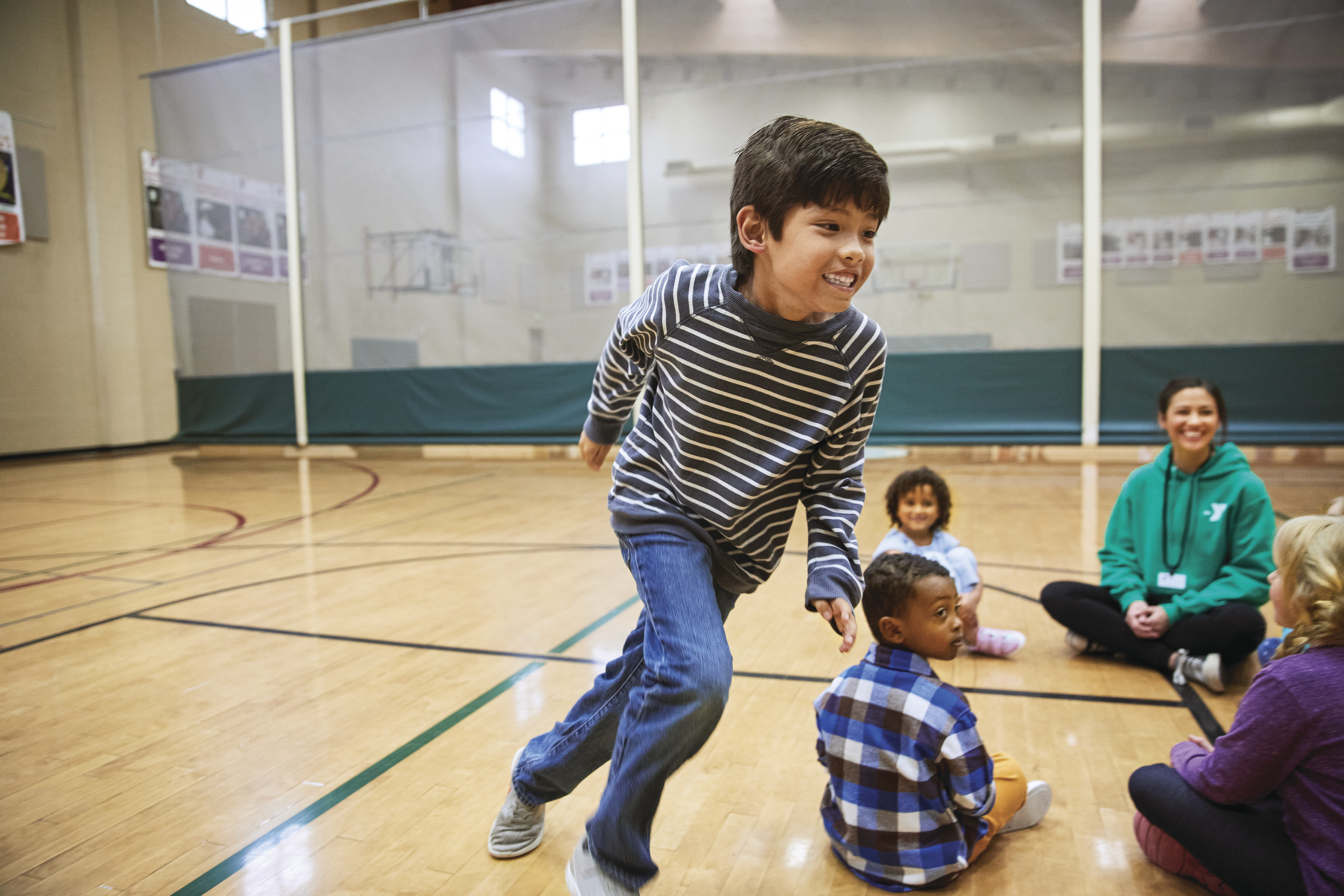 group of children playing in YMCA gymnasium 