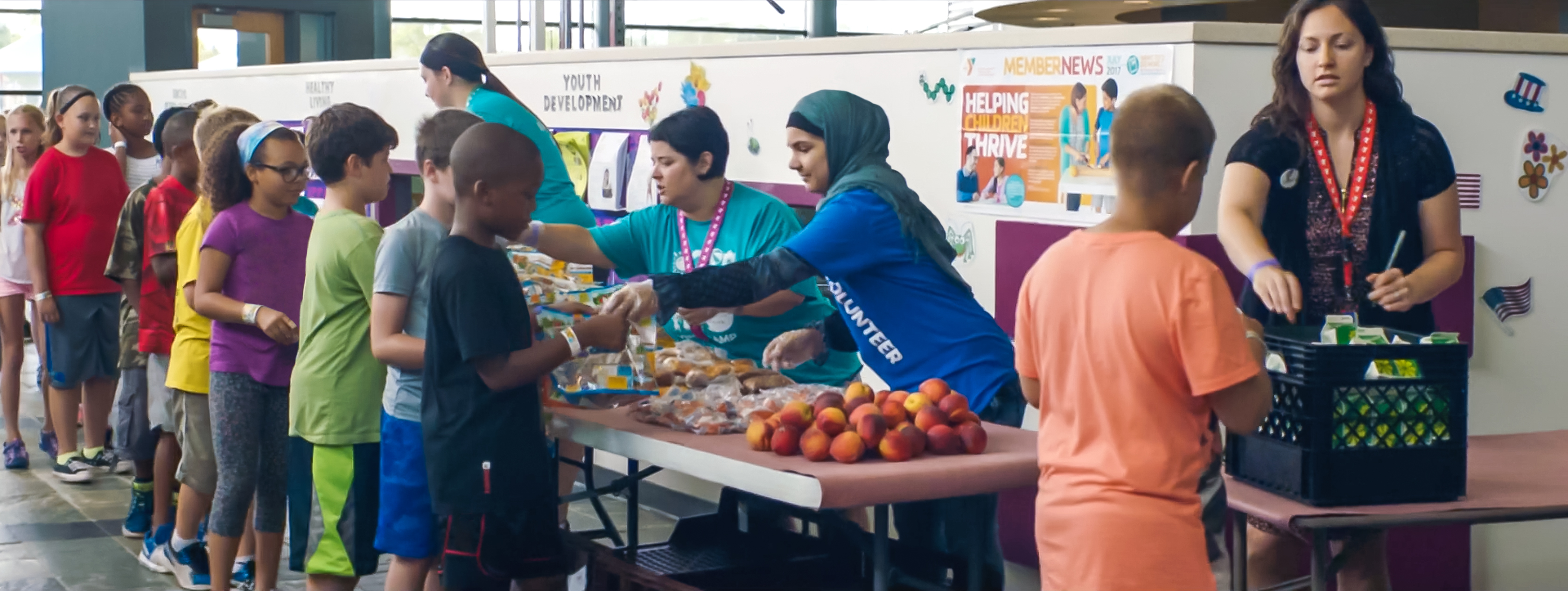 YMCA staff handing out healthy meals to youth