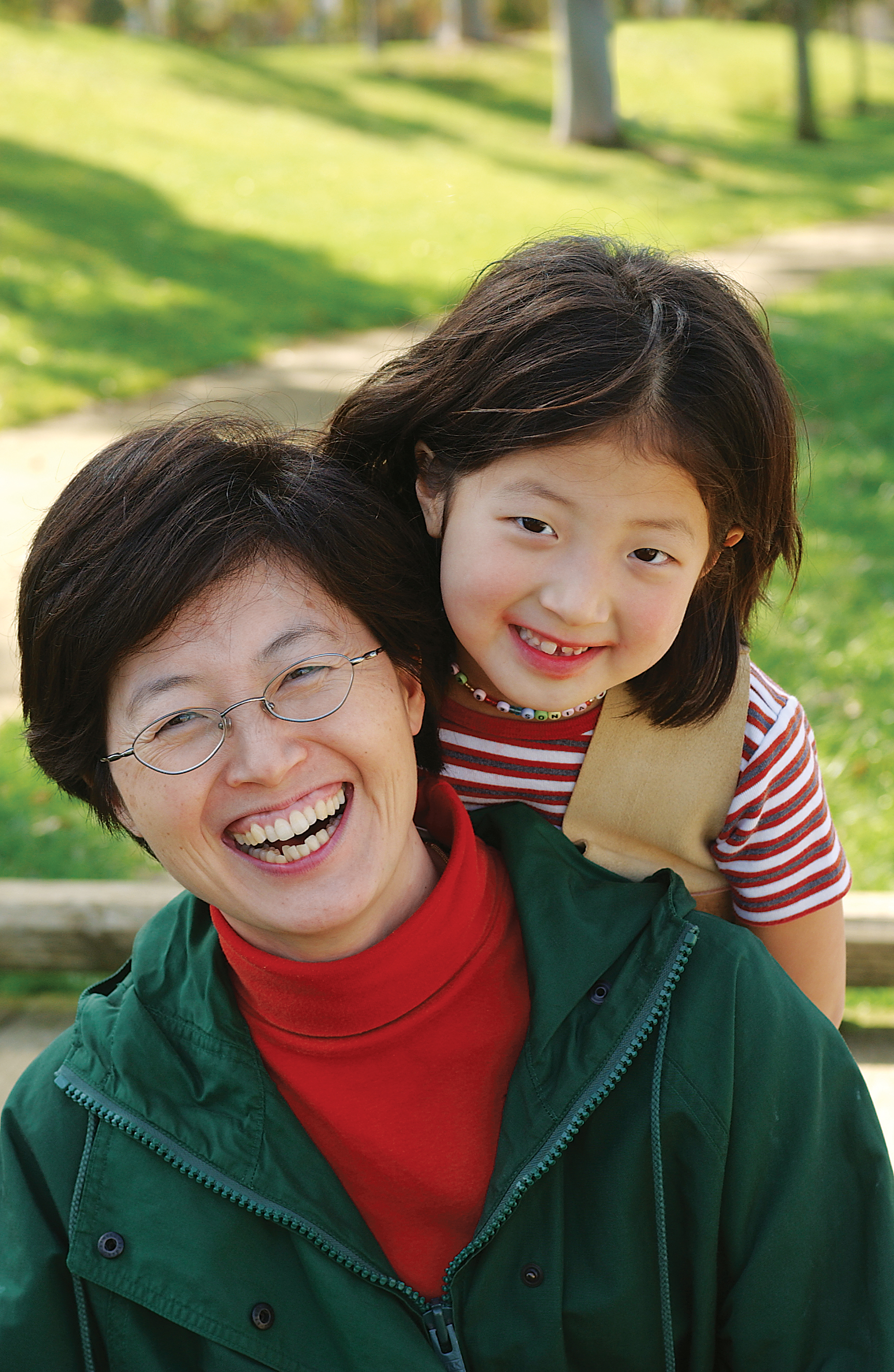 Mother and daughter posing in park - YMCA