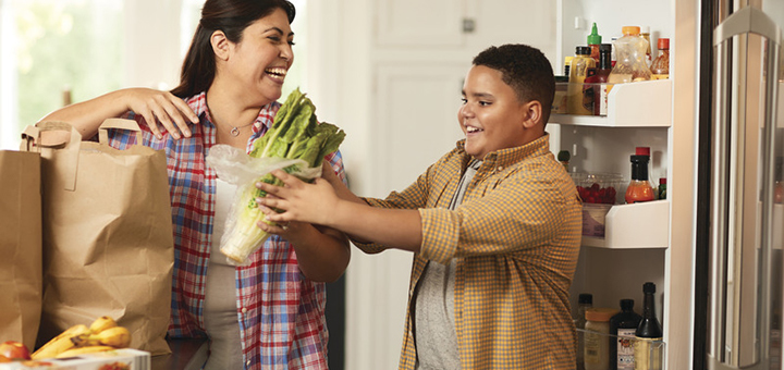 Parent and child unpacking healthy groceries