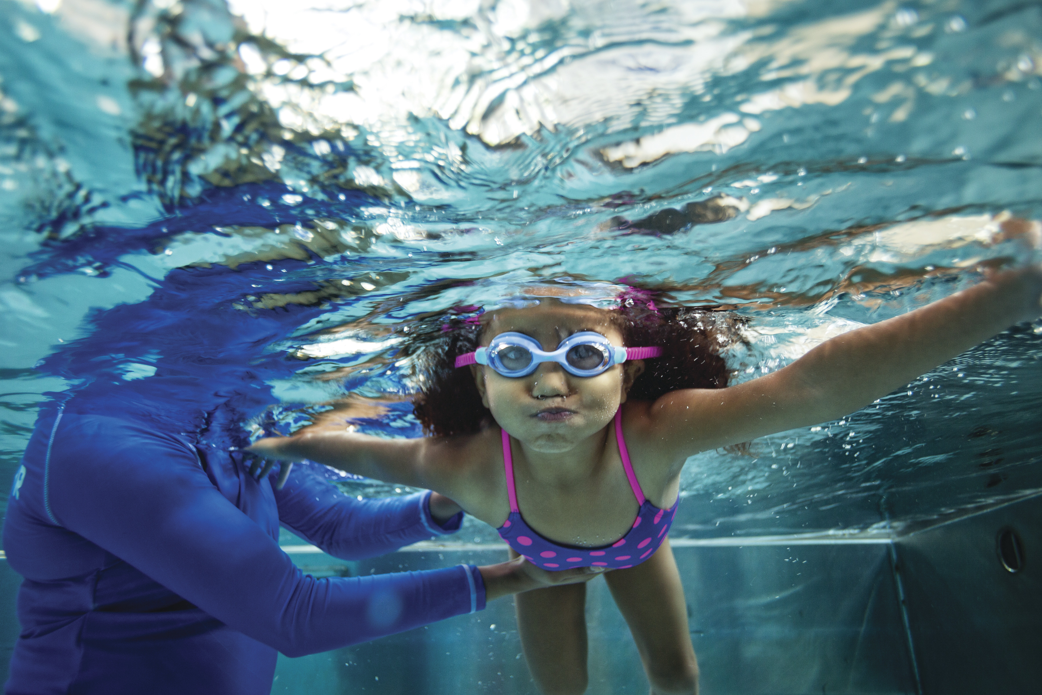 Youth learning to swim with face under water -YMCA