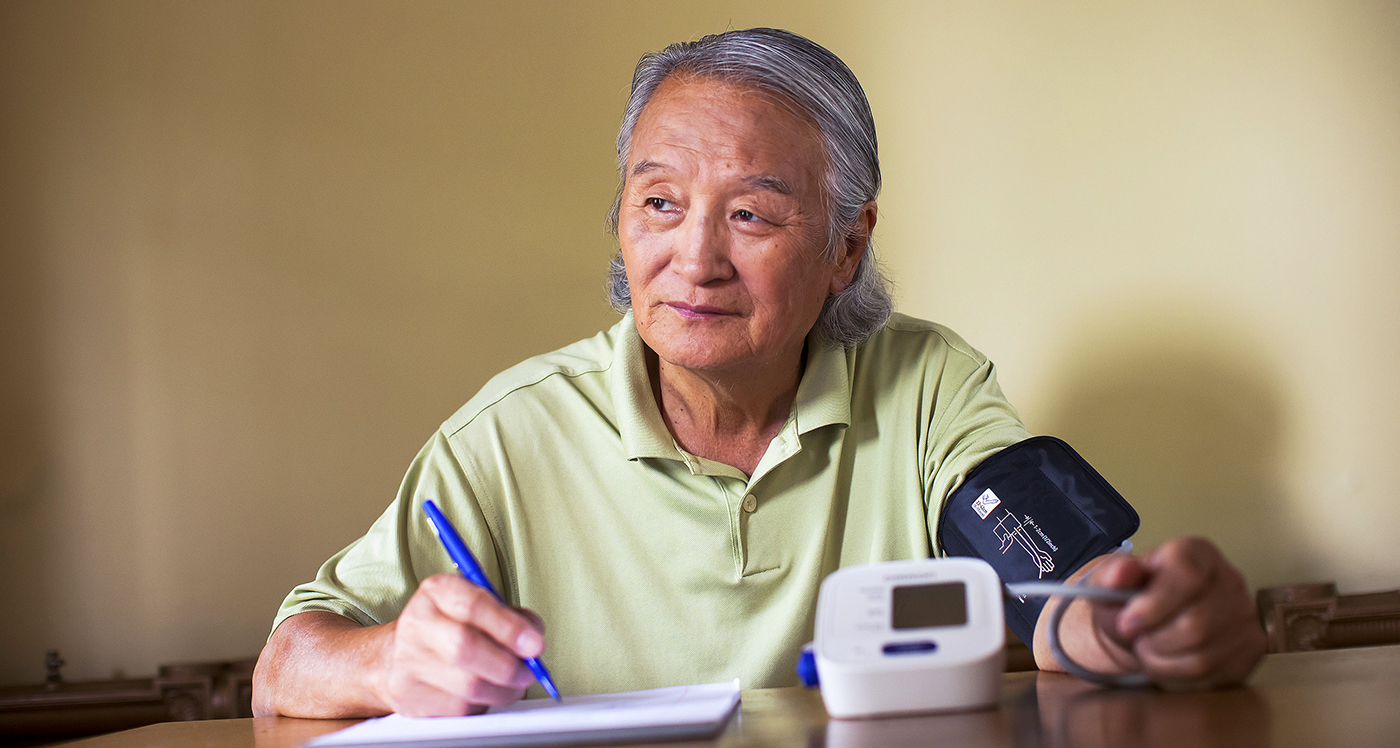 Man sitting at table taking diabetes test - YMCA