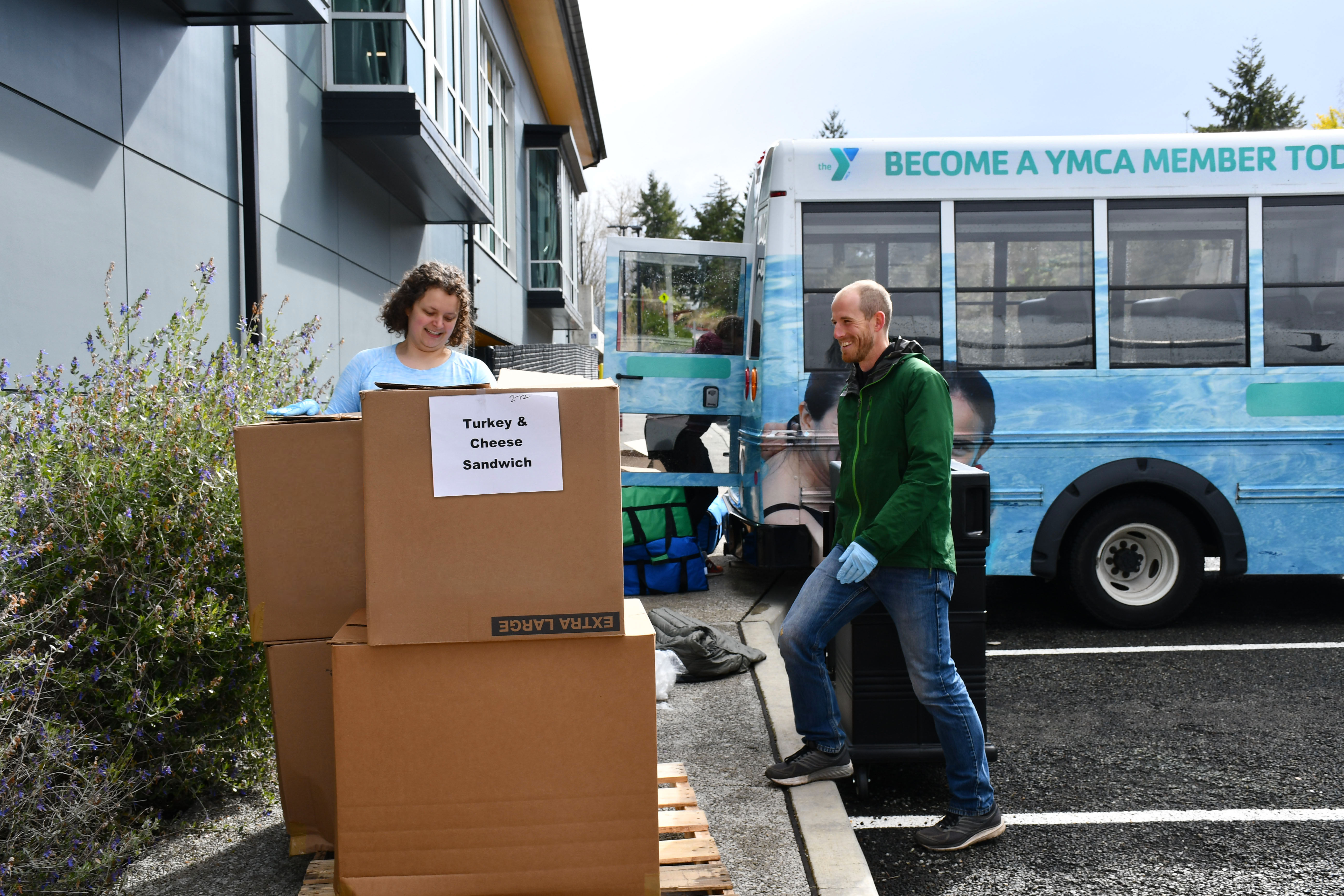 YMCA volunteers unloading food to donate