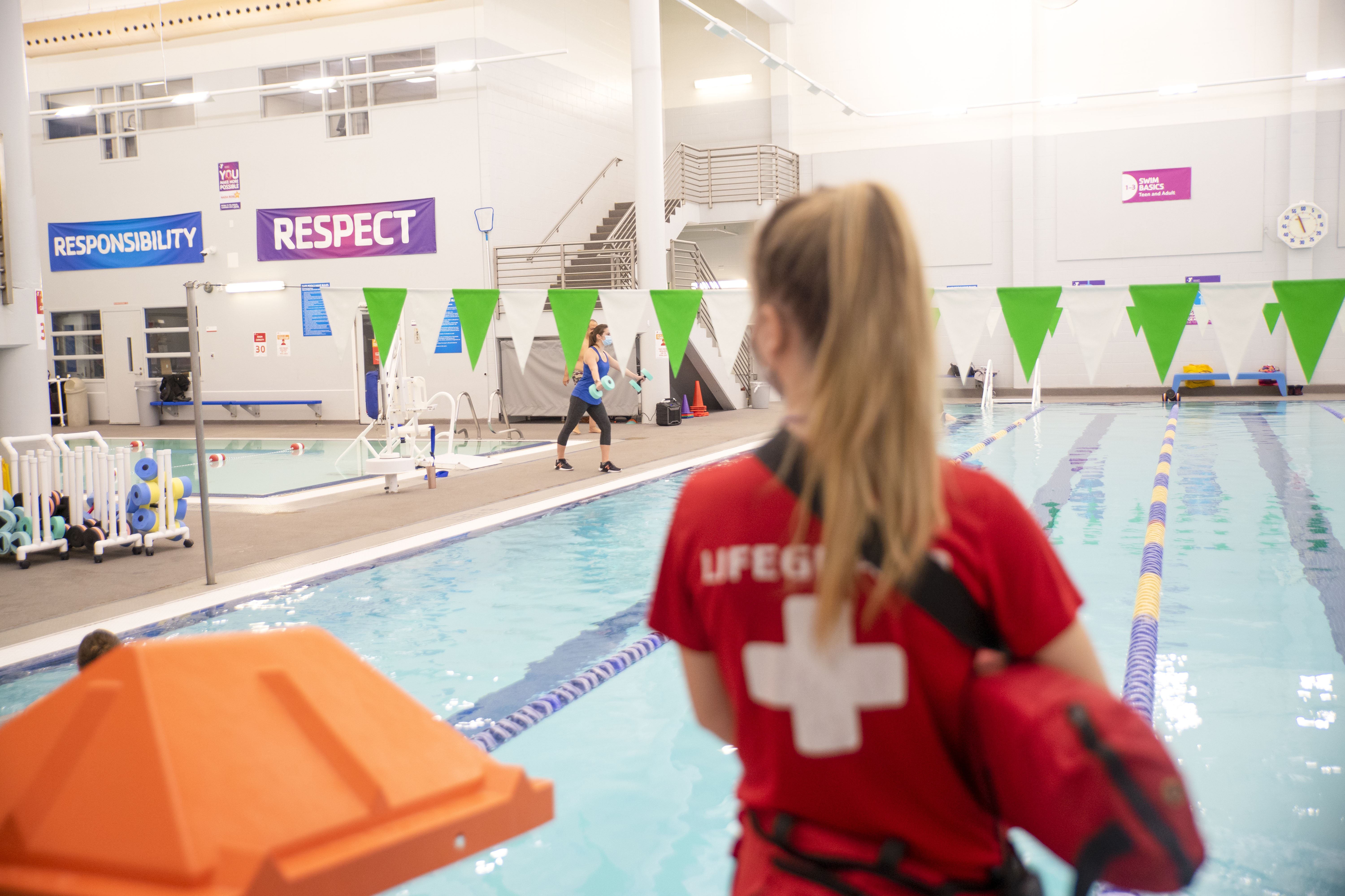 YMCA lifeguard looking over the pool