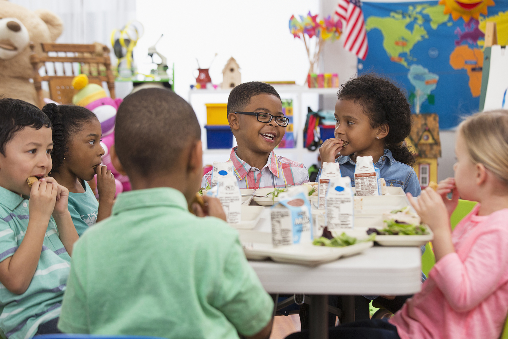 children sitting at table in Y classroom eating snacks