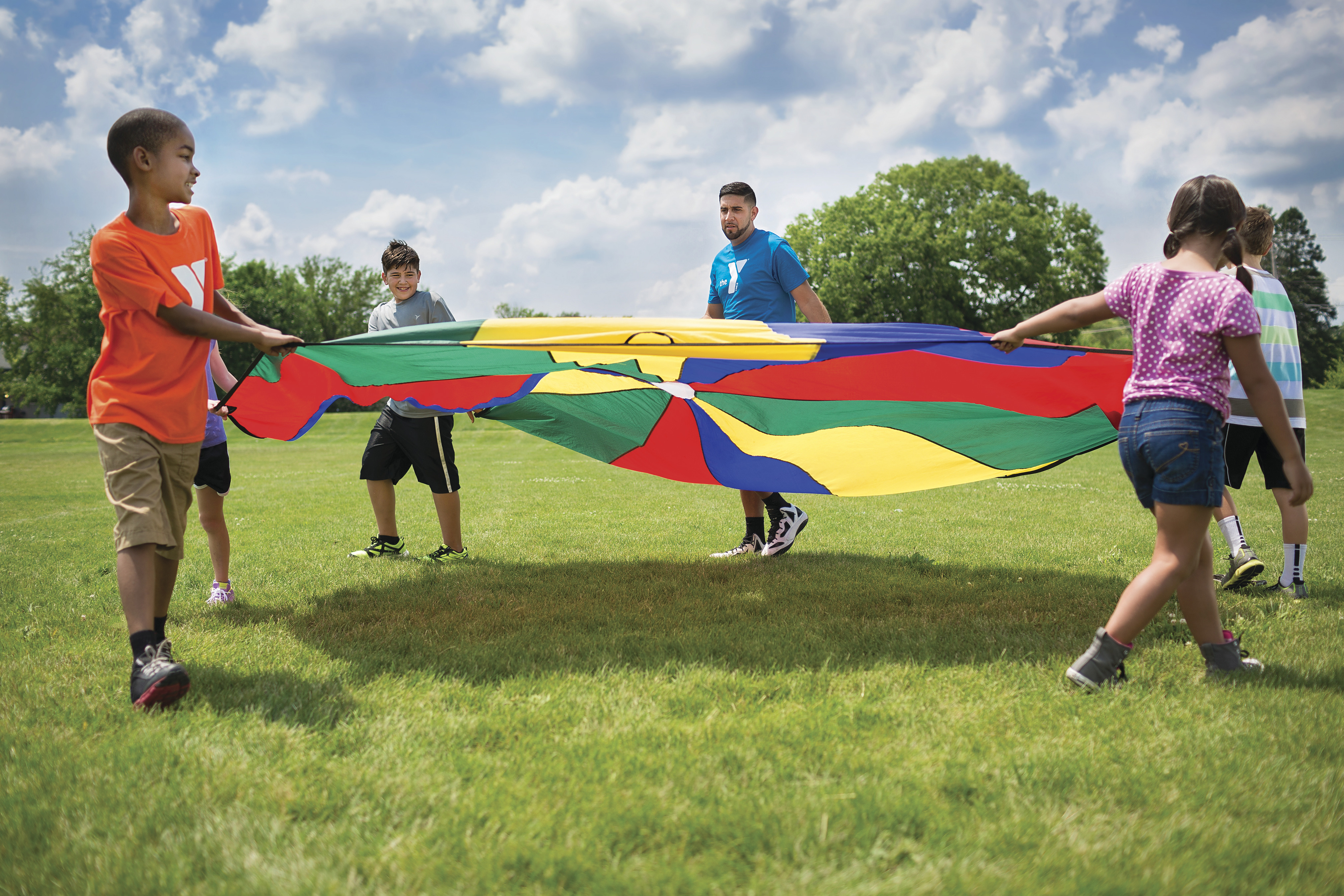 Children playing games outdoors at Y