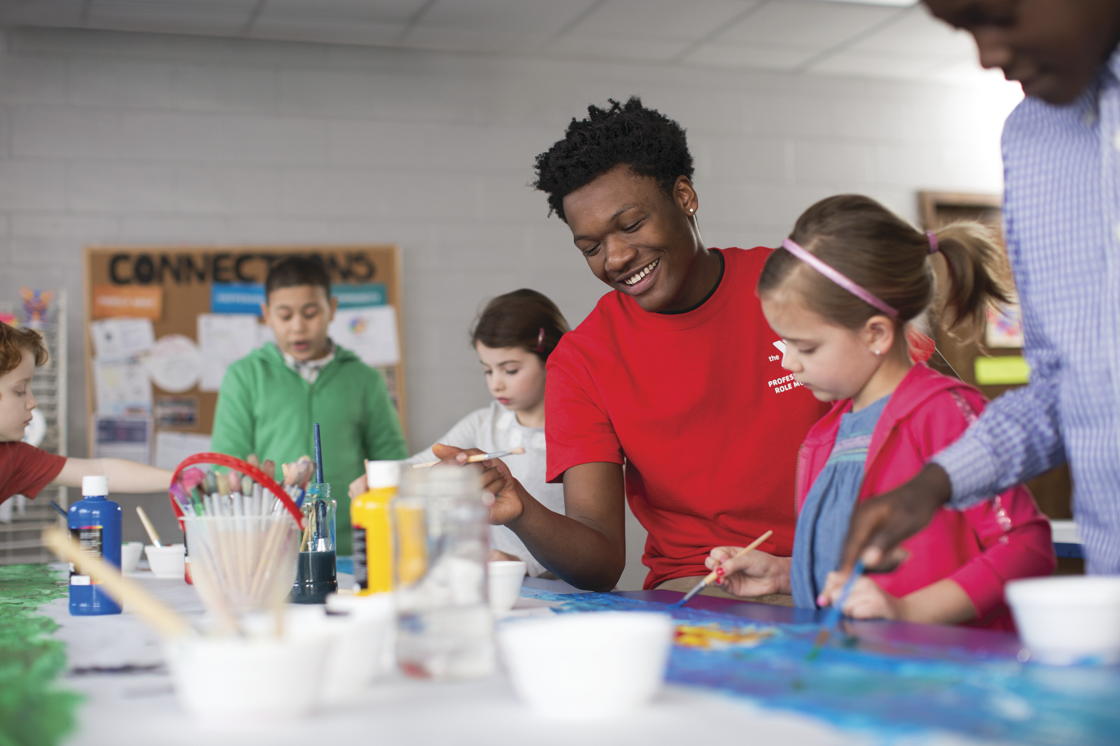 Instructor teaching children to paint