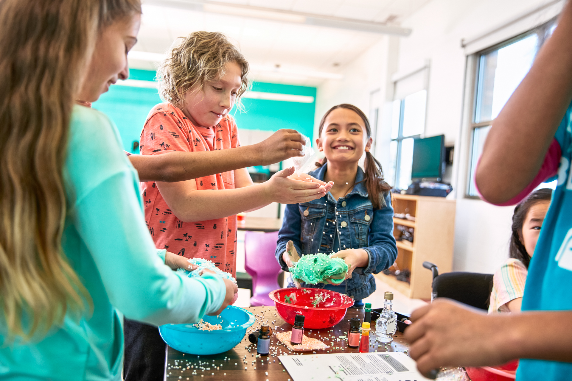 Kids smiling and engaged in a STEM experience at the Y