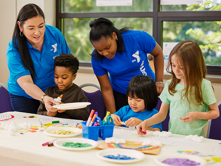 Child Care: Y staff and kids with art project.