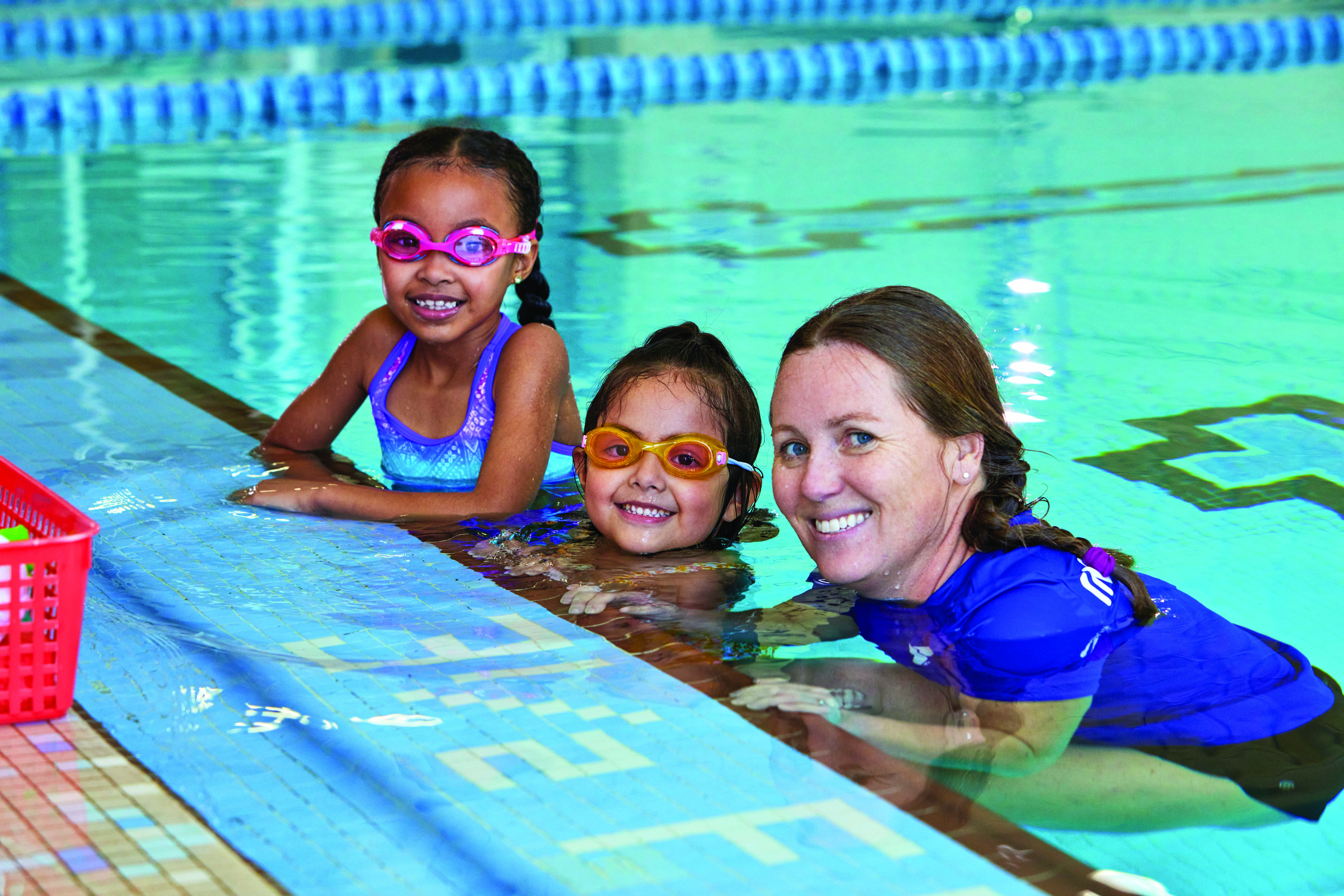 Two kids with a Y swim instructor