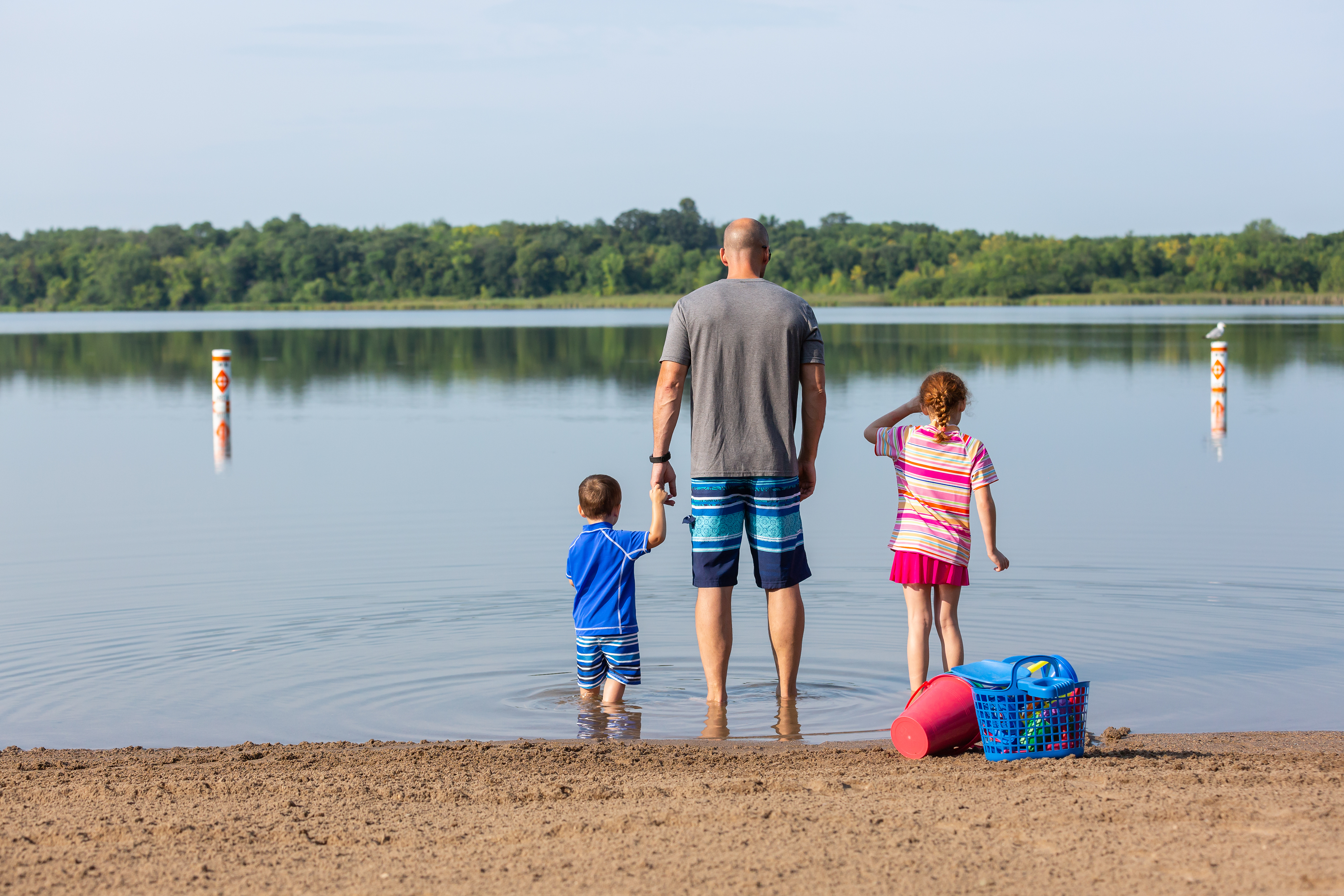 Family standing by a lake