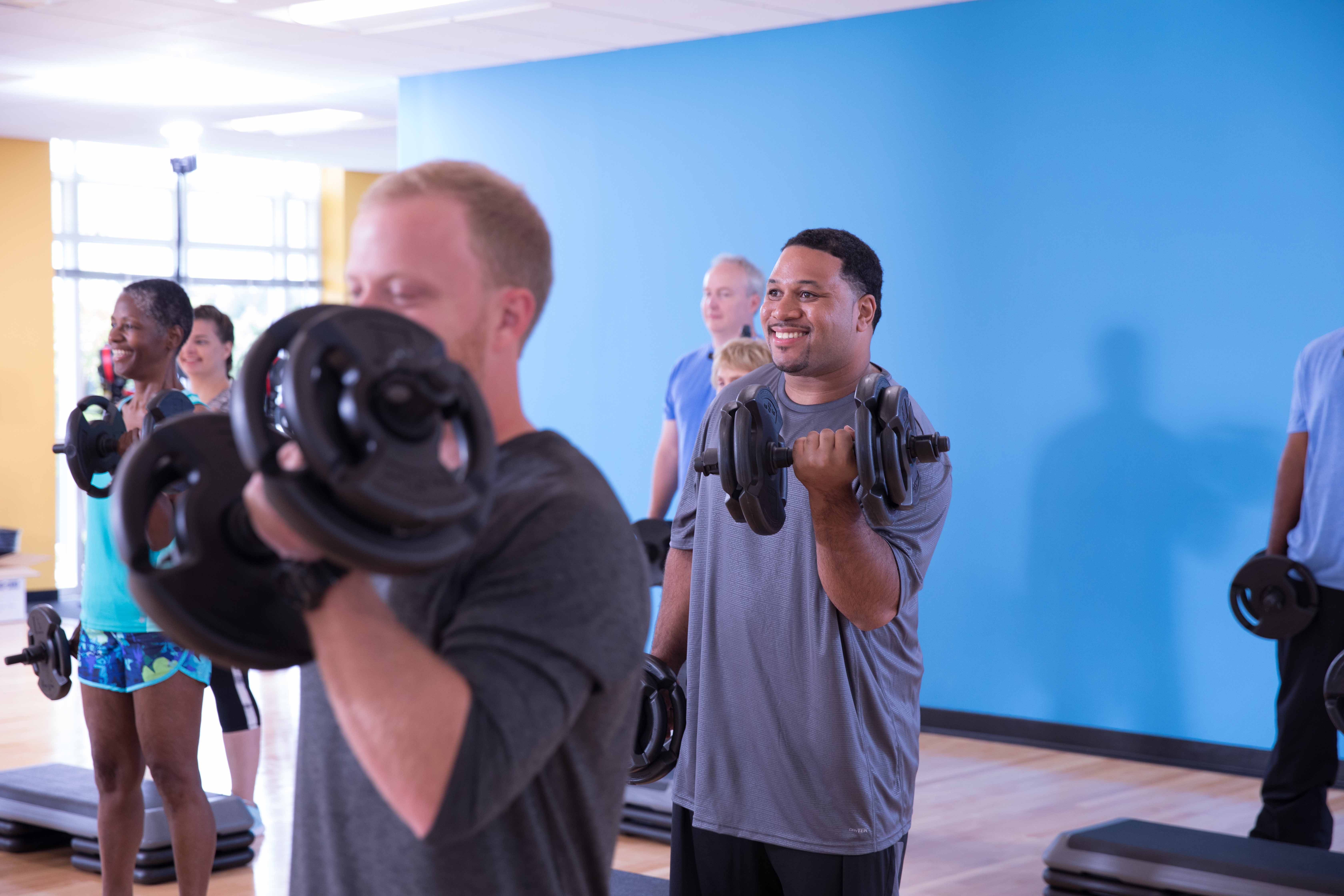 Man lifting weights at YMCA class