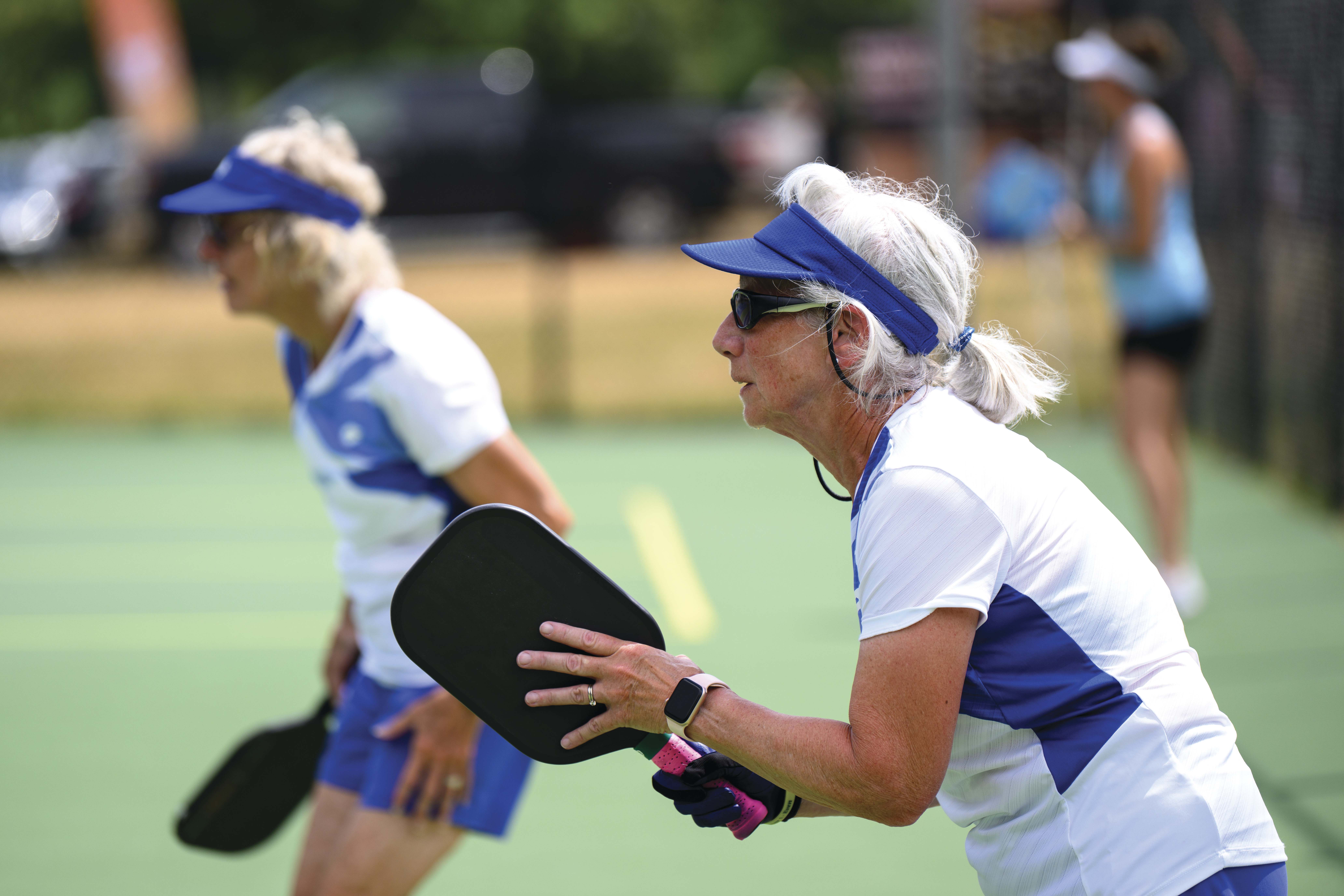 Two women playing pickleball
