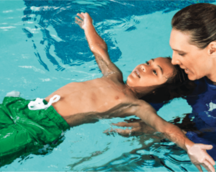 Child learning to swim in a pool