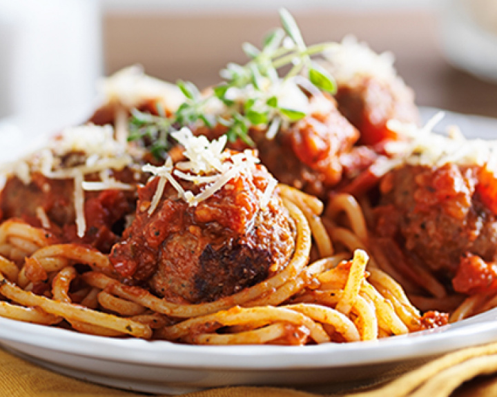 Spaghetti and meatballs in a white bowl