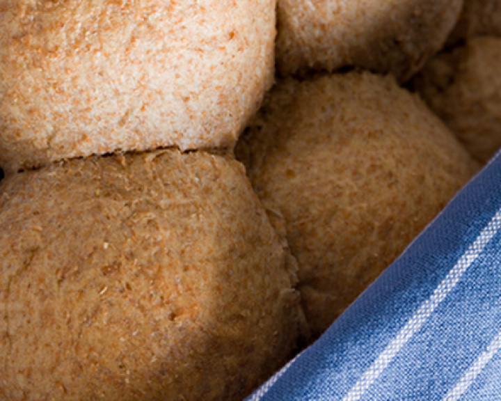 Wheat bread rolls wrapped in a blue cloth