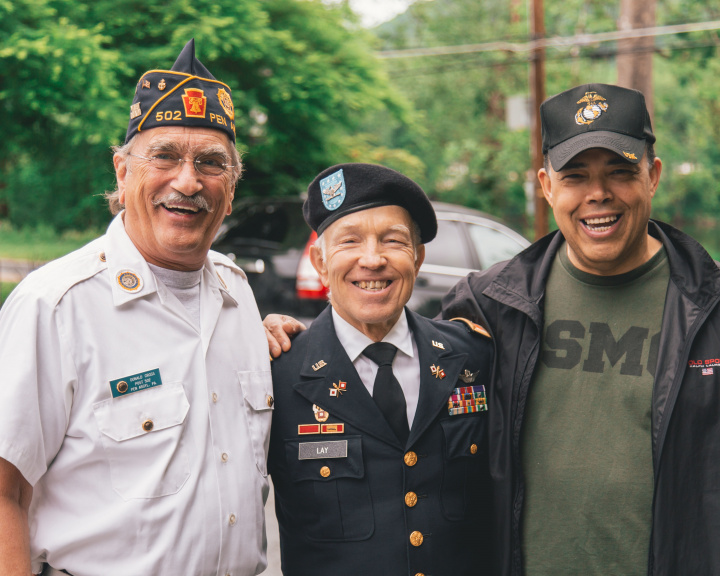 Three military veterans standing outside