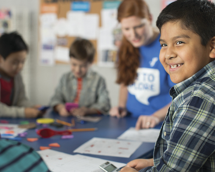 Excited, young YMCA student working through academic achievement gap