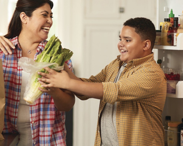 Parent and child unpacking healthy groceries