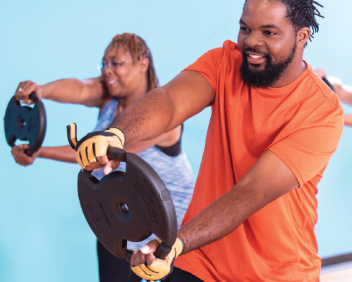 Man holding weight at YMCA class